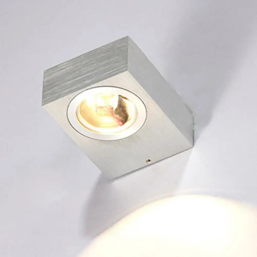 Modern black and brushed silver rgb wall lighting piece with a square brushed metallic finish and warm illumination for corridors