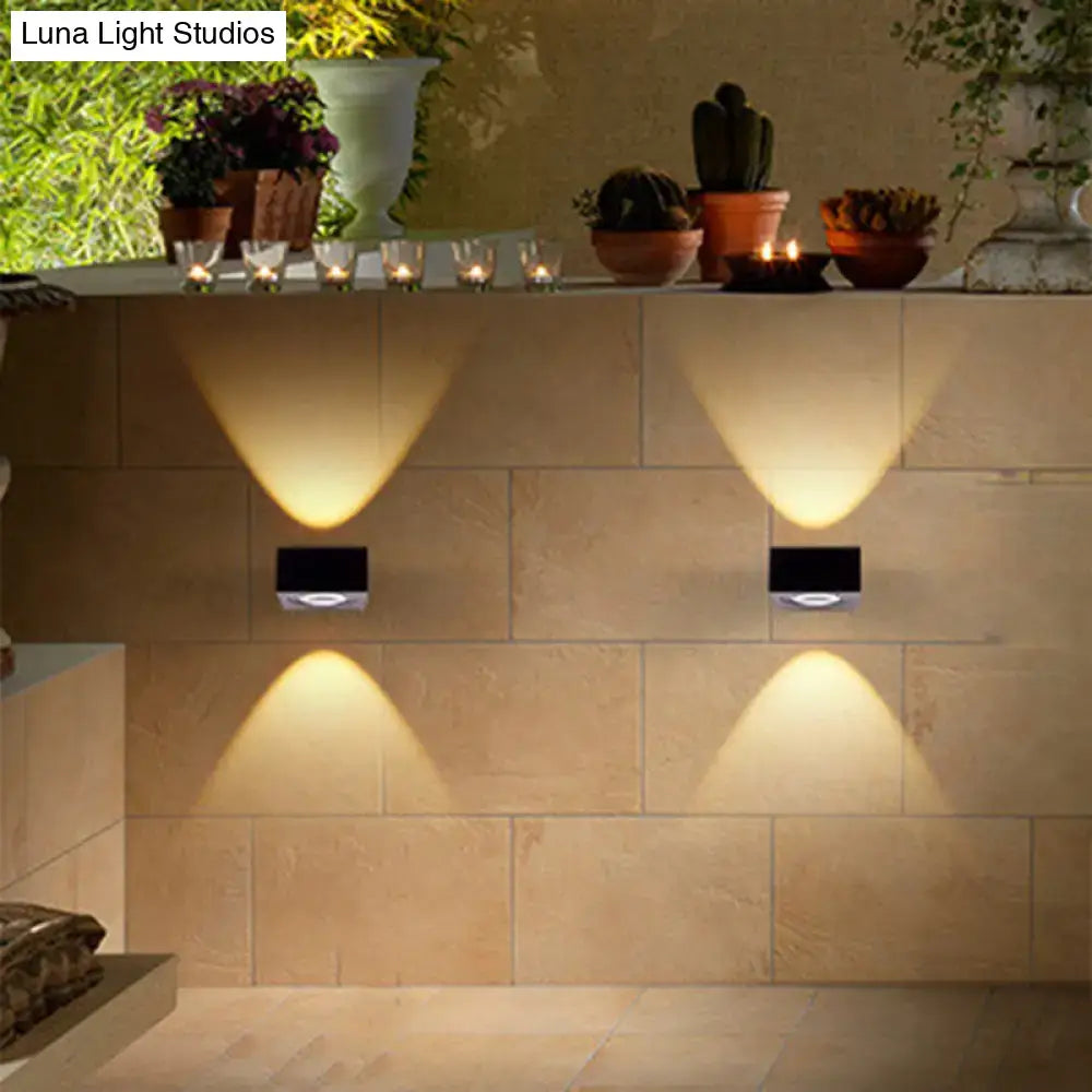 Two sleek black and brushed silver rgb wall lighting pieces cast focused beams on a beige tiled corridor surface