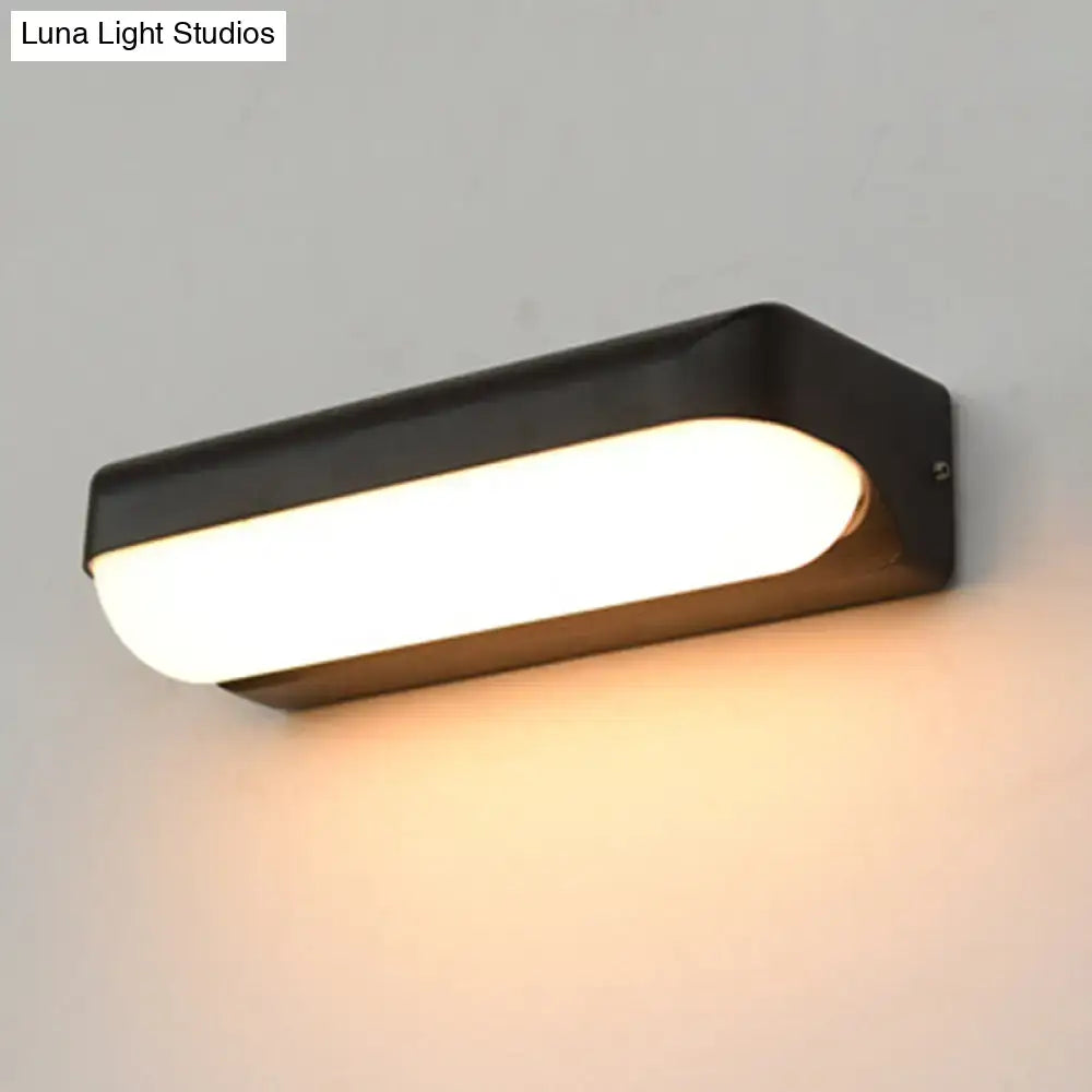Modern black capsule flush wall sconce with frosted glass diffuser wall-mounted lamp emitting warm white light