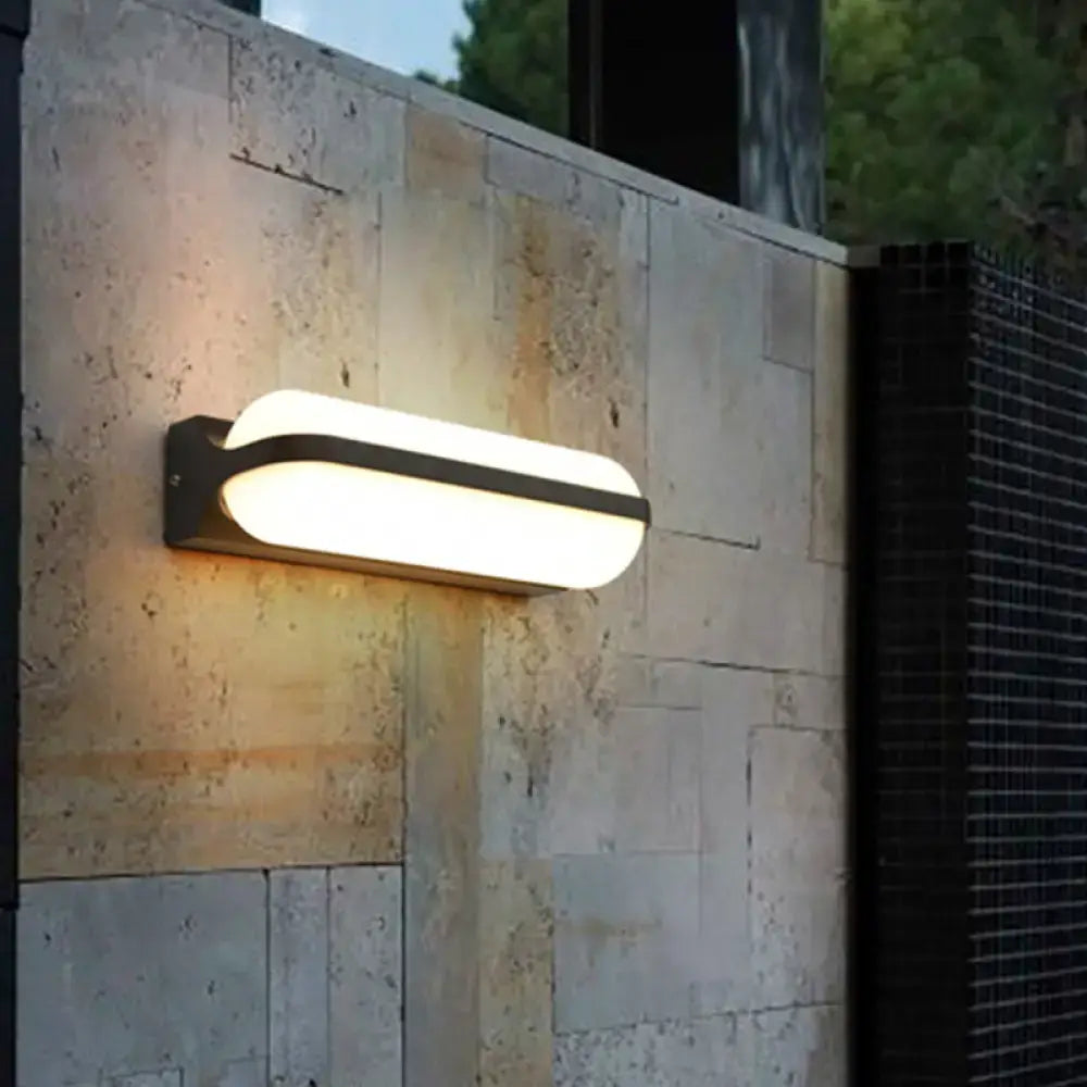 Modern black capsule flush wall sconce wall-mounted lamp with frosted glass diffuser emitting warm white light