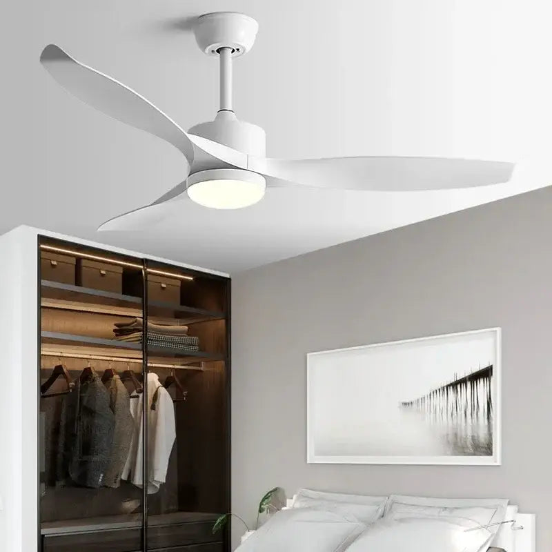 White ceiling fan with sleek modern blades and integrated lighting paired with black ceiling fan remote control for living room