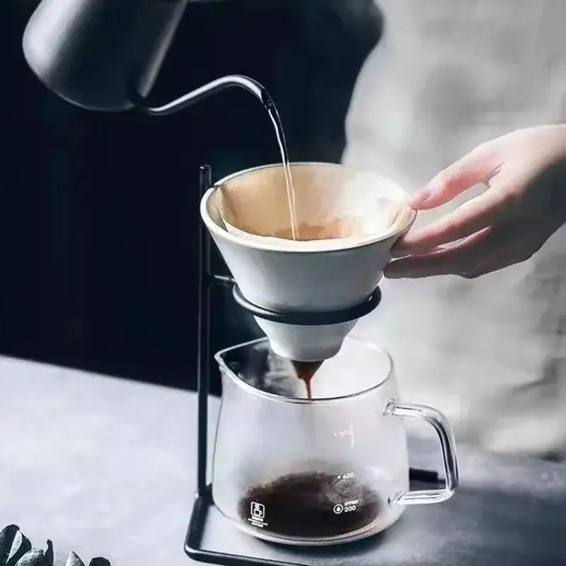 White ceramic pour-over coffee dripper with black metal stand from decorbites coffee barista set for modern kitchen use
