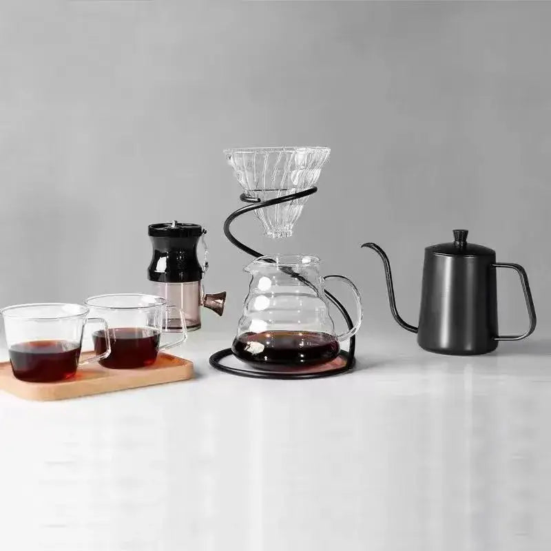 Modern black ceramic coffee barista set featuring a clear glass pour-over dripper with faceted conical design on black metal stand