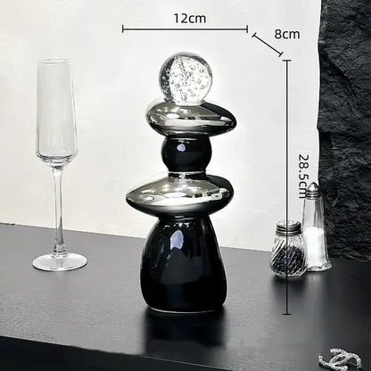 Modern black ceramic decorative crystal ball statue with stacked rounded tiers and a clear glass bubble top for living room decor
