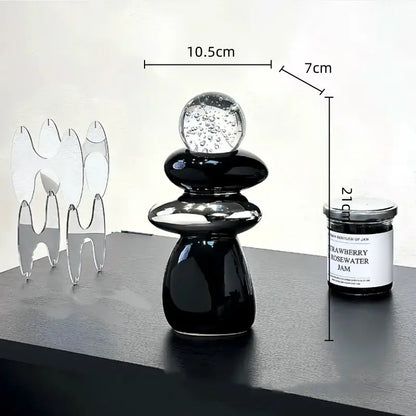 Modern black ceramic decorative crystal ball statue with stacked smooth forms and bubble-filled glass sphere for living room decor