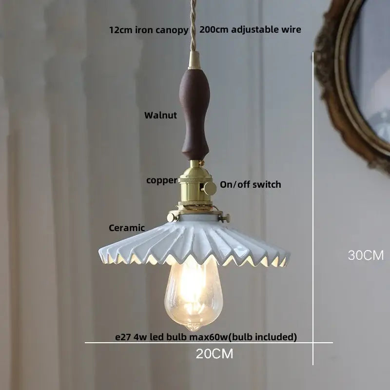 Modern black ceramic led pendant light with scalloped ceramic shade, walnut handle, and brass decorbites black ceramic details