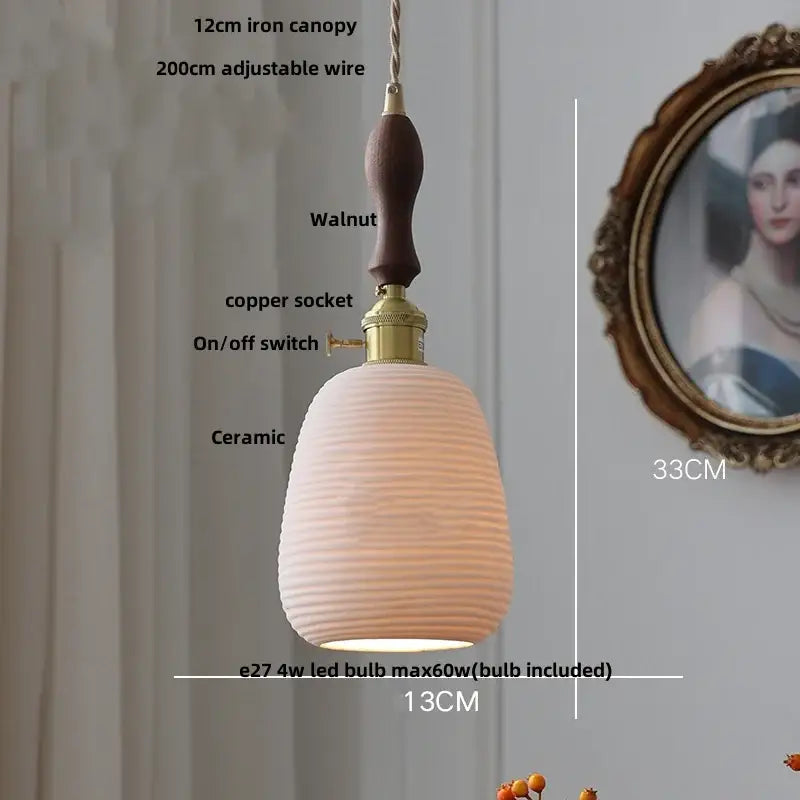 A warm-toned black ceramic led pendant light with ribbed texture, walnut handle, and brass details for kitchen decorbites
