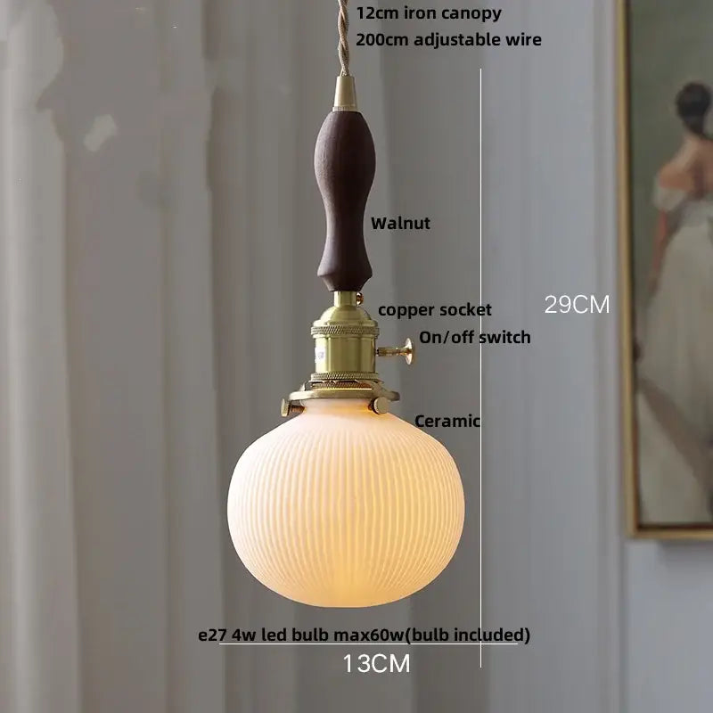 Modern black ceramic led pendant light with warm ribbed ceramic shade walnut-finished iron canopy and brass socket decorbites black ceramic