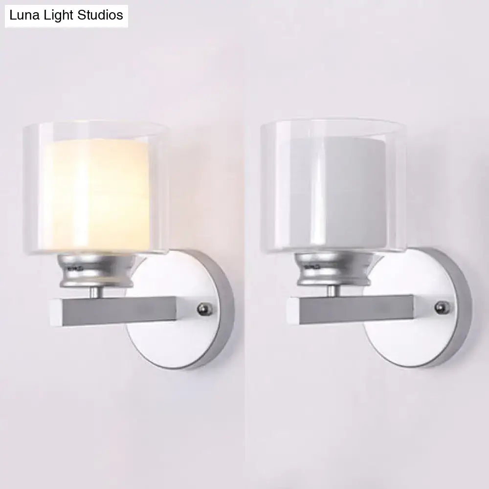 Modern black and chrome clear glass sconce with sleek silver metal frame wall mounted for bedroom lighting, one lit one off
