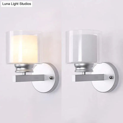 Modern black and chrome clear glass sconce with sleek silver metal frame wall mounted for bedroom lighting, one lit one off