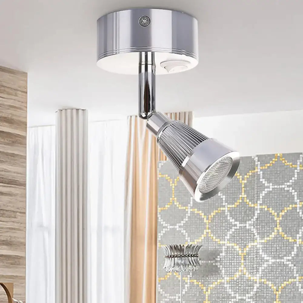 Modern black and chrome smd wall light with adjustable spotlight, sleek design, and ribbed lens for bedroom use