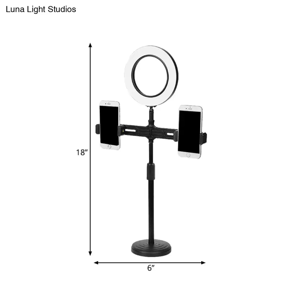 Black adjustable stand with 18 inch circular ring light, two phone holders, and usb port wall light fixture for bedroom