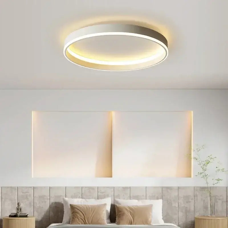 Modern black decorbites circular led ceiling light with sleek white and metallic finish emitting warm ambient glow
