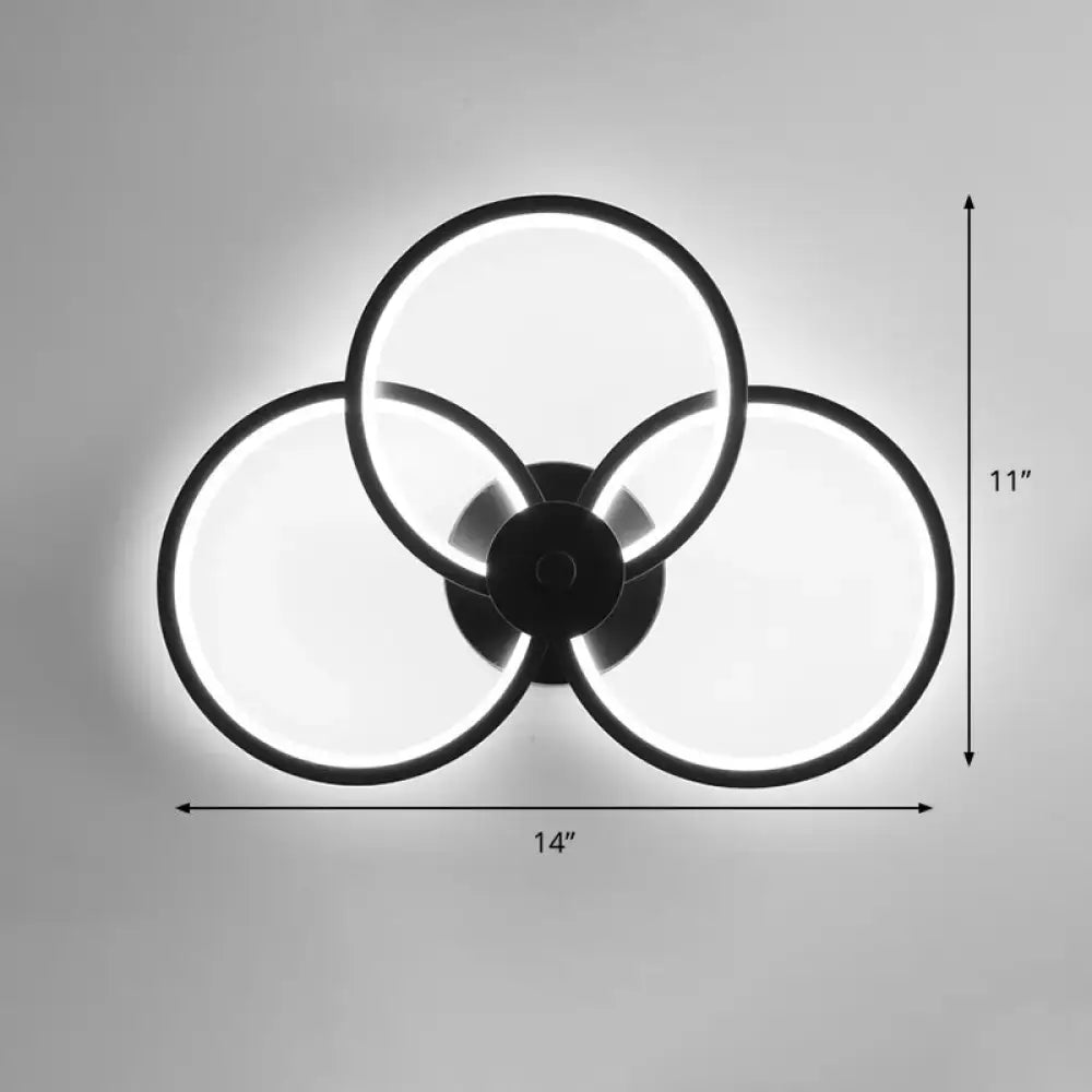 Modern black circular led light fixture with three overlapping illuminated rings for bedroom wall sconce with remote control