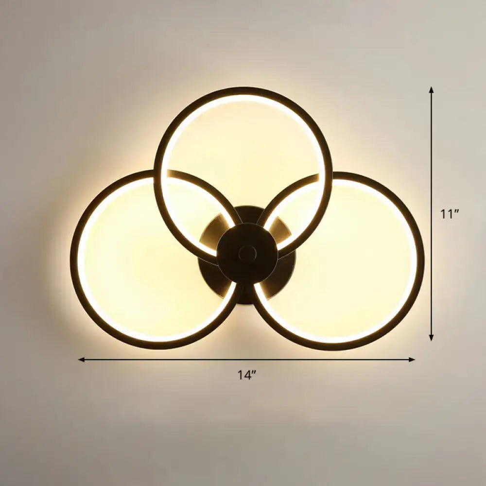 Modern black circular led light fixture wall sconce with three overlapping illuminated rings and remote control features