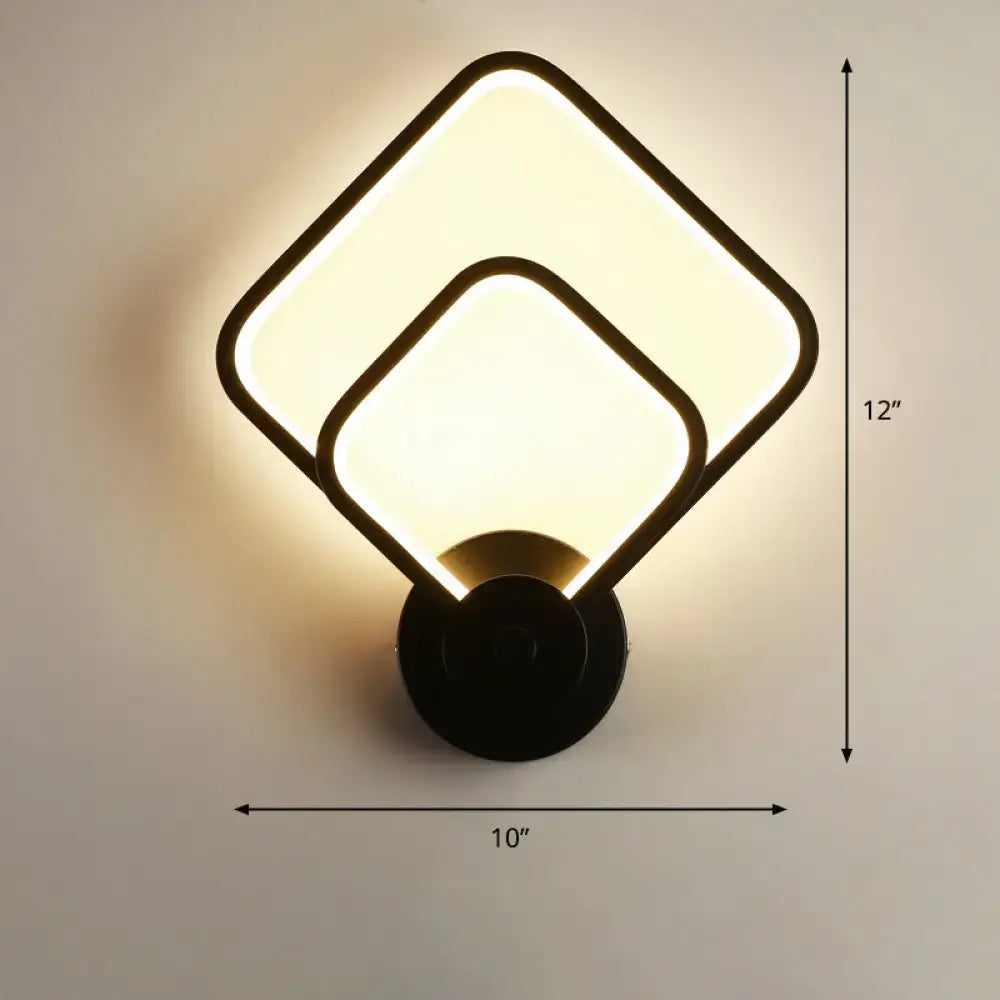 Modern black circular led light fixture wall sconce with overlapping square panels and warm glow for bedroom use with remote control
