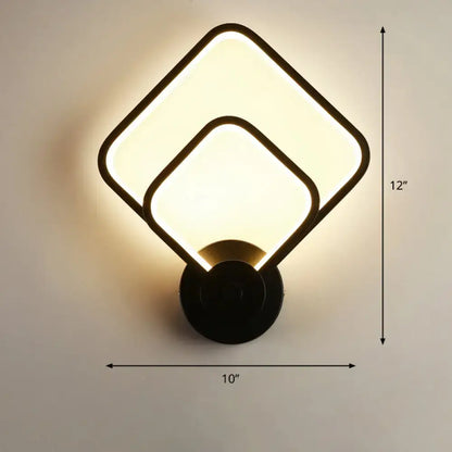 Modern black circular led light fixture wall sconce with overlapping square panels and warm glow for bedroom use with remote control