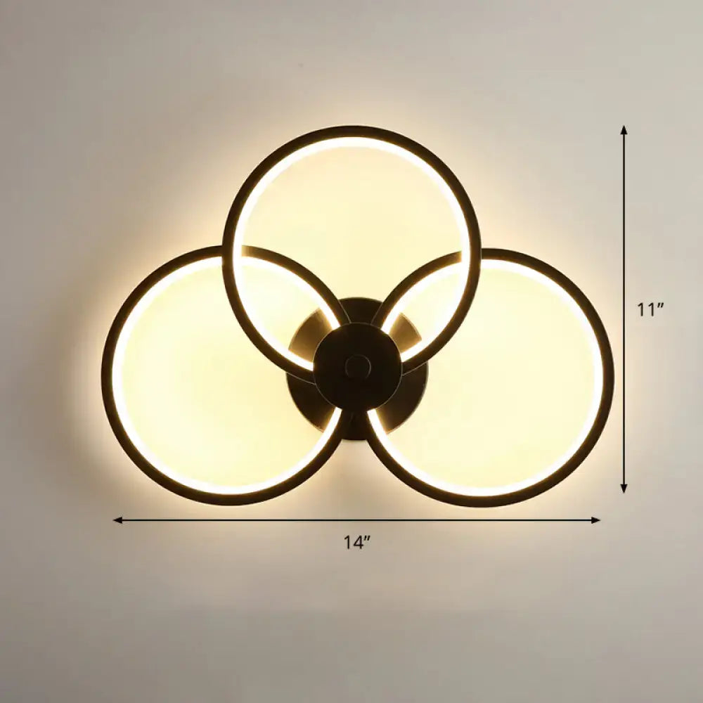 Modern black circular led light fixture wall sconce with three overlapping illuminated rings and remote control function