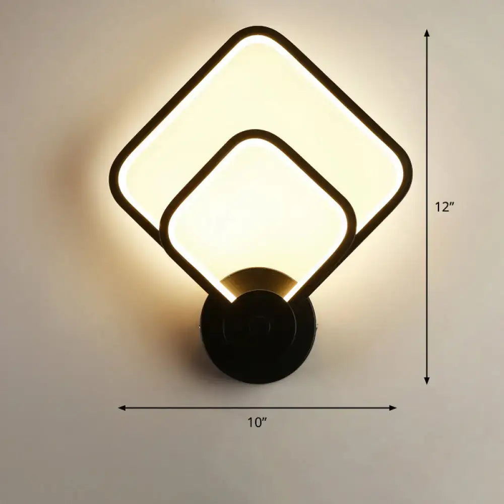 Modern black circular led light fixture with two overlapping square panels emitting warm glow for bedroom wall sconce with remote control