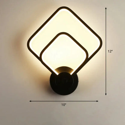Modern black circular led light fixture with two overlapping square panels emitting warm glow for bedroom wall sconce with remote control