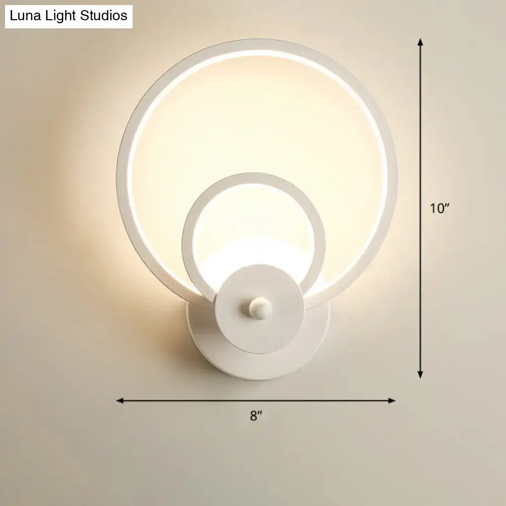 Modern black circular led light fixture with remote control and white concentric ring wall sconce for ambient bedroom lighting