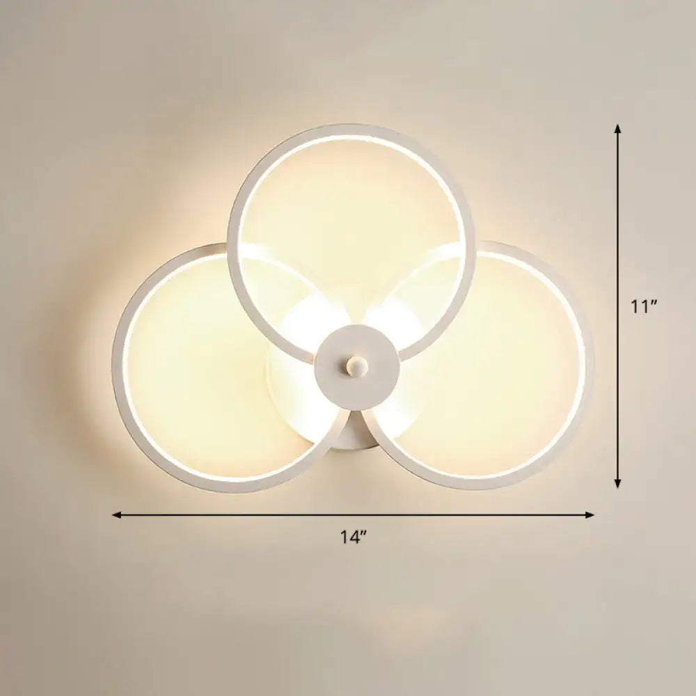 Modern black circular led light fixture bedroom wall sconce with three overlapping illuminated white rings and remote control
