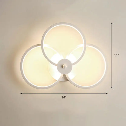 Modern black circular led light fixture with three overlapping illuminated rings for bedroom wall sconce with remote control