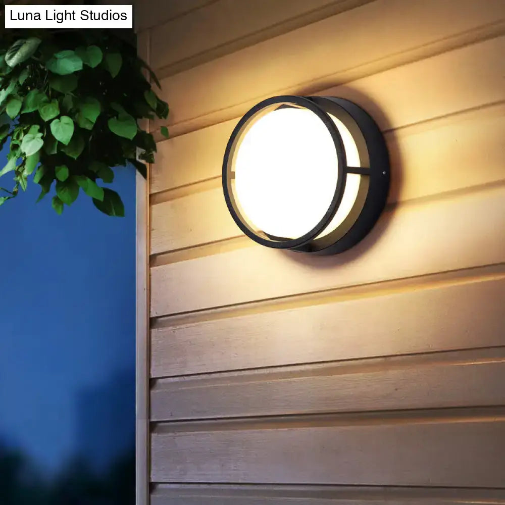 Modern black circular led wall lamp with warm color lighting for outdoor use and diffused light design