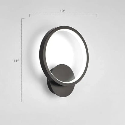 Modern black circular led wall sconce light fixture with a sleek minimalist design and illuminated ring, inches high