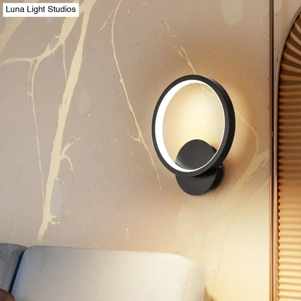 Modern black circular led wall sconce light fixture with glowing ring minimalist design, ideal for bedroom lighting