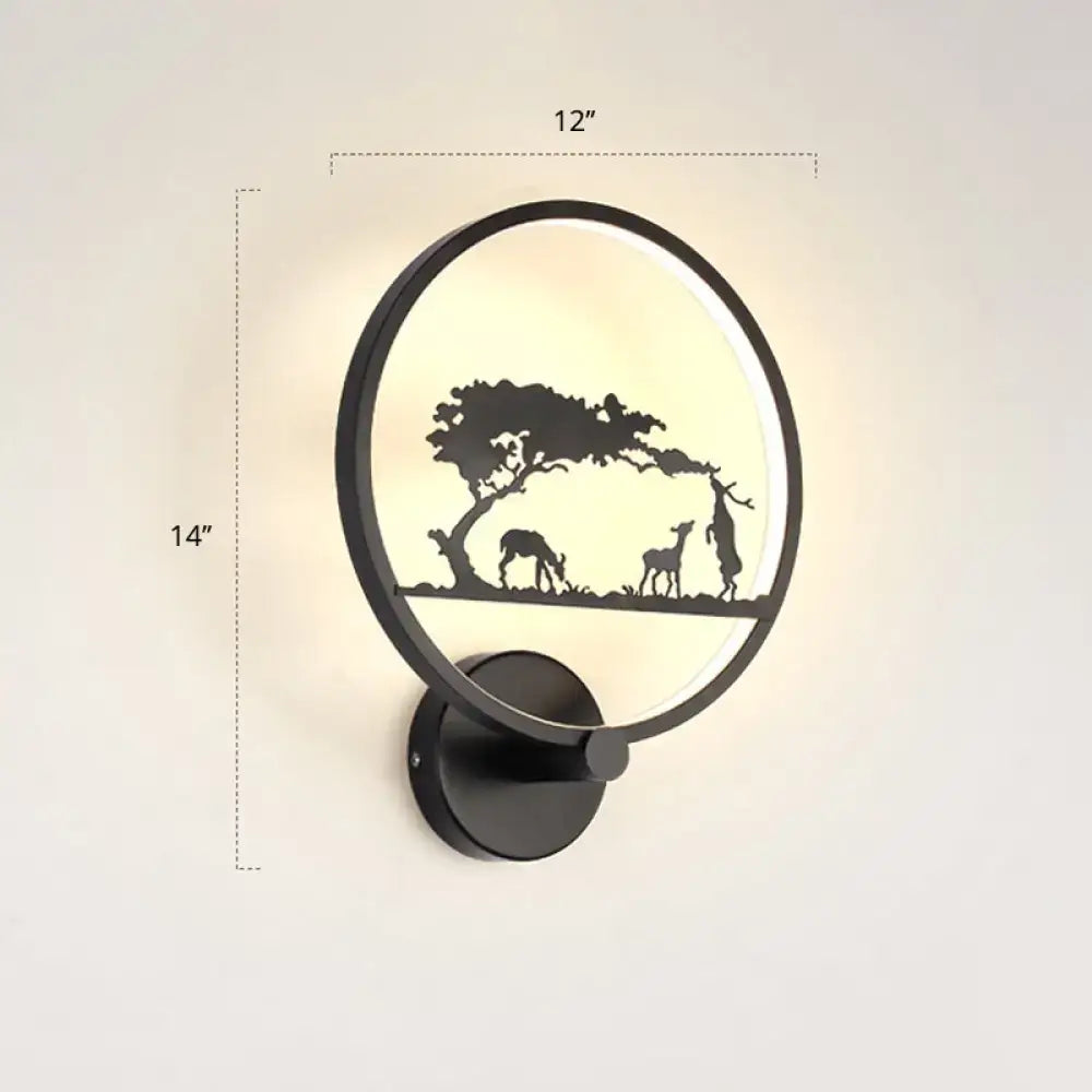 Modern black circular led wall sconce light fixture with deer and tree silhouette design, warm glowing backlight, 12 inches high