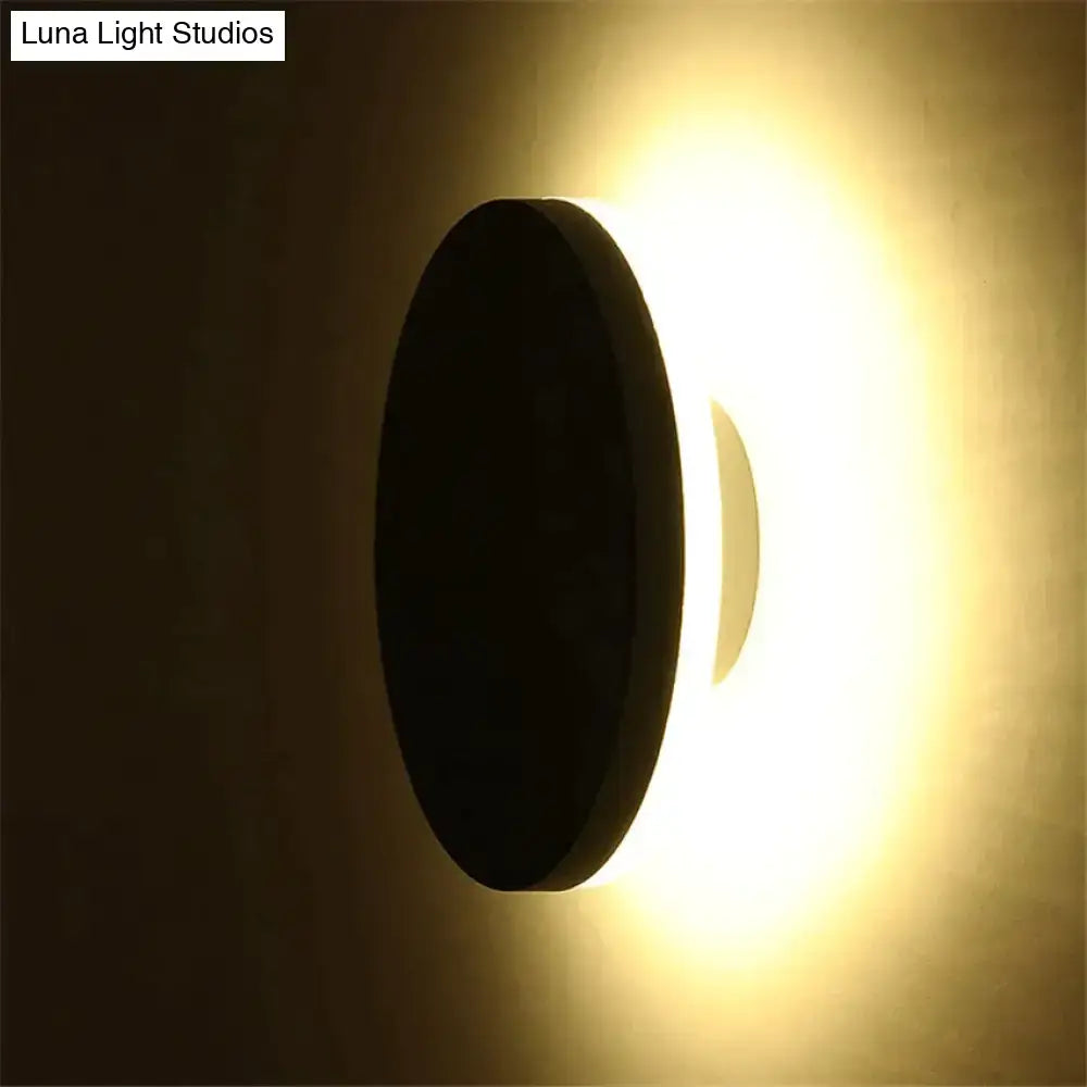 Modern black circular waterproof wall lamp set with sleek minimalist design emitting warm ambient light for bedroom