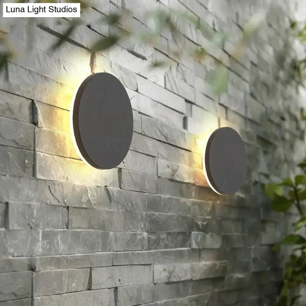 Modern black circular waterproof wall lamp set with sleek matte gray finish and warm ambient lighting for bedroom use
