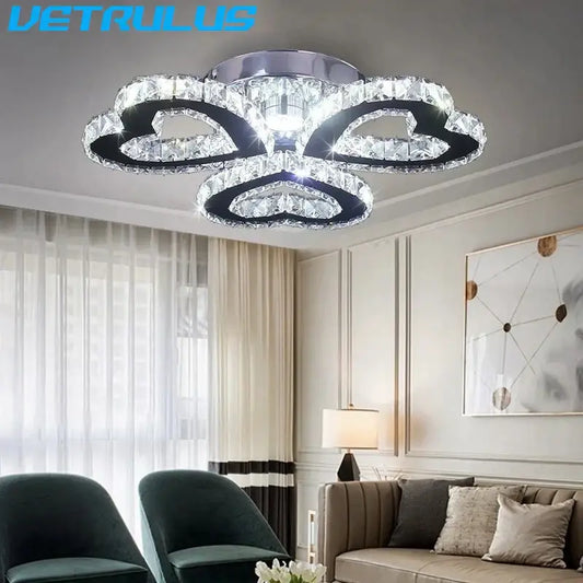 A modern black and clear crystal led ceiling chandelier with four acrylic rings and chrome decorbites crystal led mount