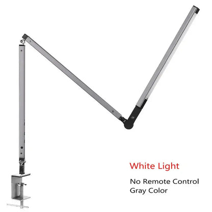 Modern black clip led desk lamp with gray adjustable metallic body and black joints emitting white light for office use