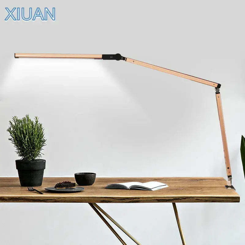 A sleek rose gold articulated desk lamp with adjustable arms complementing decorbites clip led desk office light
