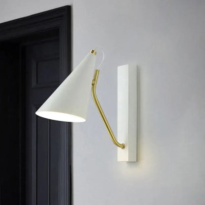 Modern white cone shade wall sconce with gold brass arm mounted on white plate suitable for led incandescent fluorescent lighting