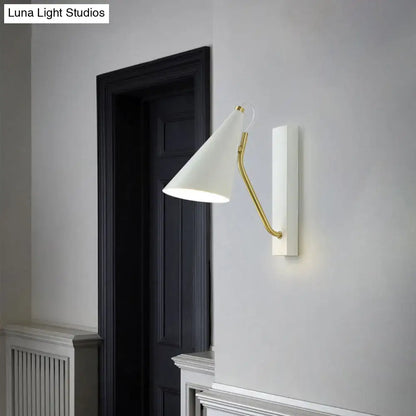White conical wall sconce with a gold-toned brass arm featuring a modern cone shade for bedroom LED incandescent lighting