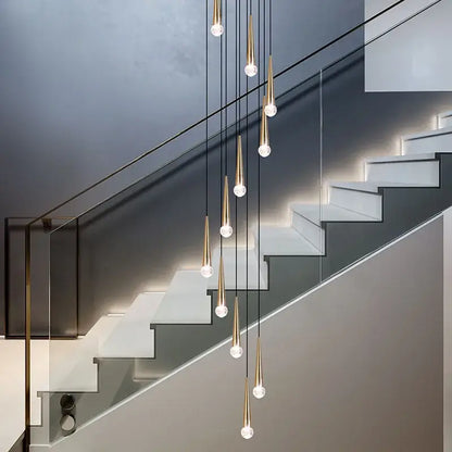 Modern gold-toned pendant lighting fixture with clear glass globes in a crystal led stair decorbites crystal led design