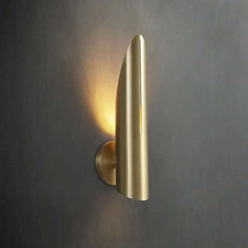 A sleek brushed gold wall lamp with modern teardrop design and warm light from decorbites black copper luxe series