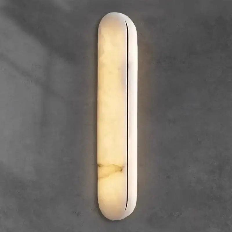 A sleek alabaster wall light with a polished finish and vertical seam for modern black copper marble decorbites black copper