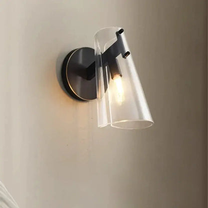 Modern black copper wall lamp featuring a metal frame and clear glass cone shade ideal for bedroom decorbites black copper