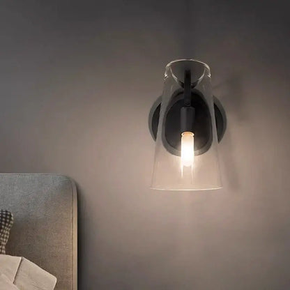 Modern wall lamp with black copper base and glass pendant featuring an exposed bulb decorbites black copper design