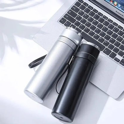Two modern 400ml stainless steel vacuum travel mugs with black and silver finishes and textured grips with wrist straps