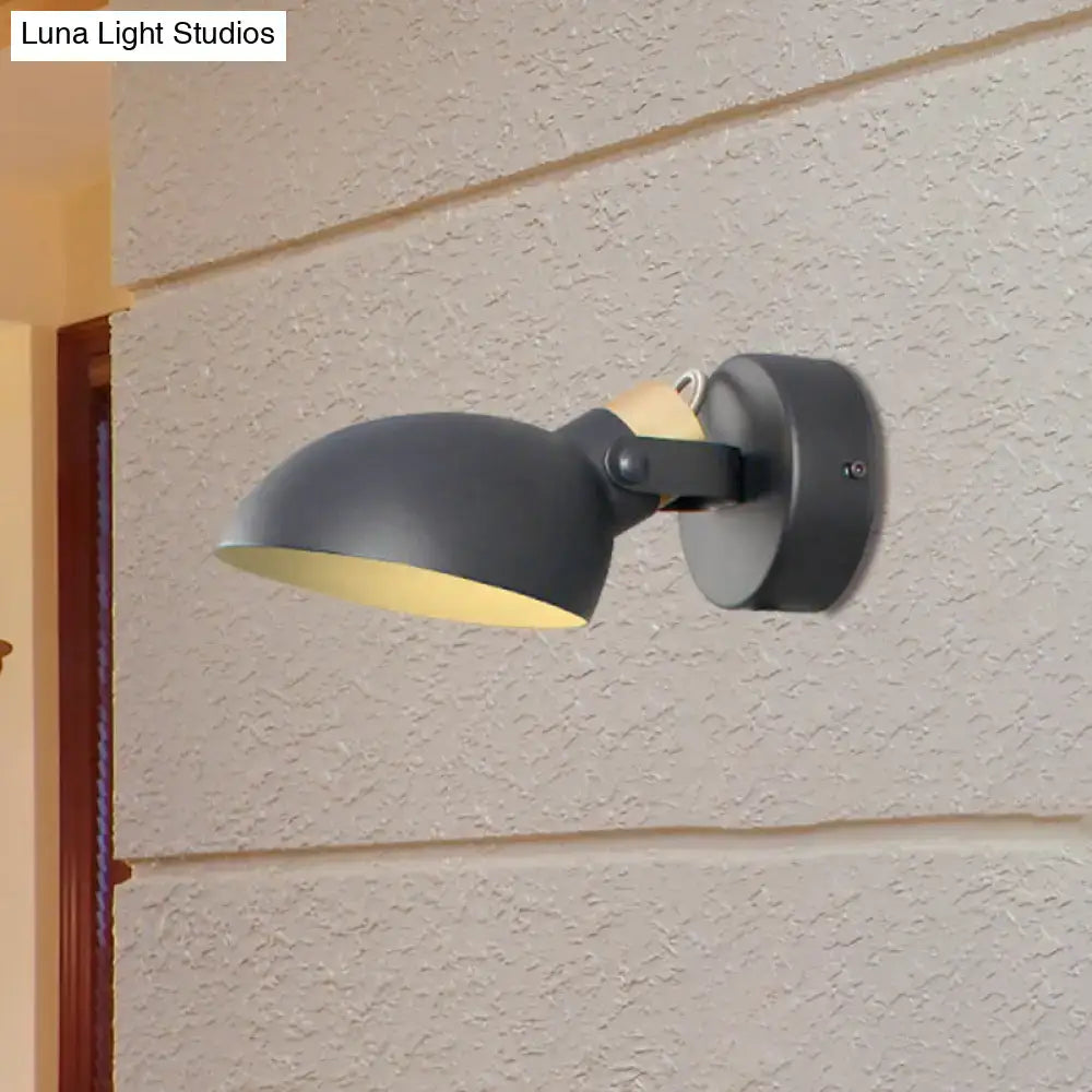 Modern black and cream wall sconce light with a matte black finish and yellow interior lining for bedroom use