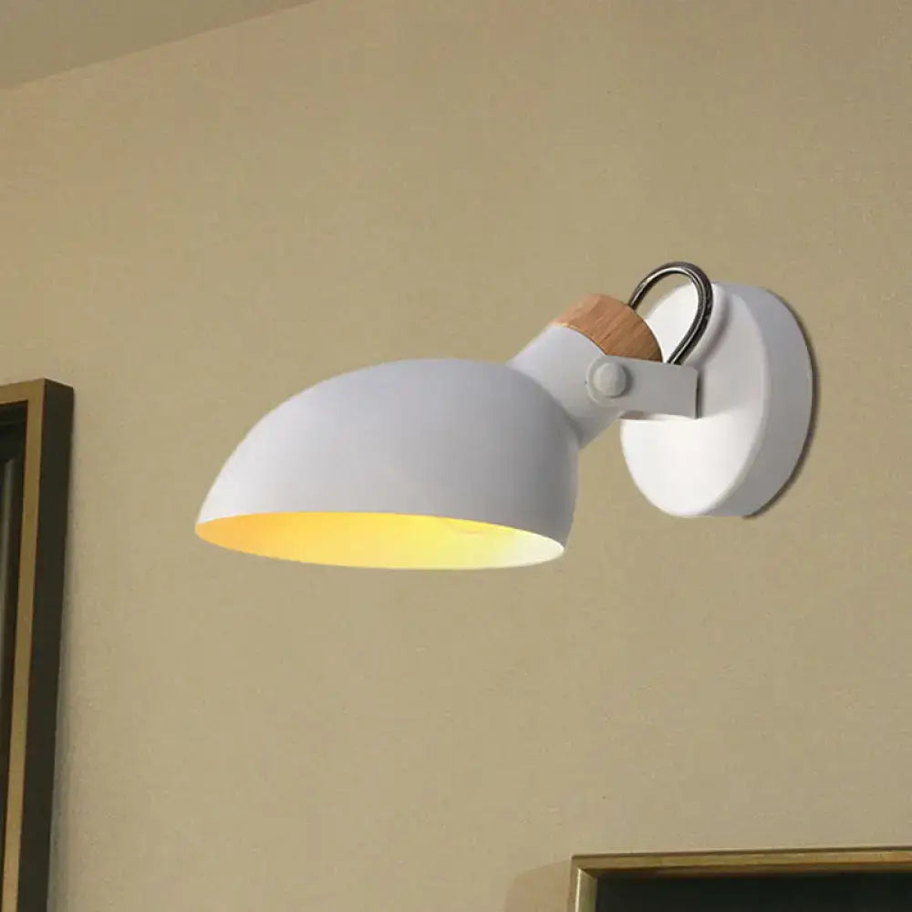 Modern black and cream wall sconce light with wooden accent and warm yellow glow in a stylish bedroom lamp design