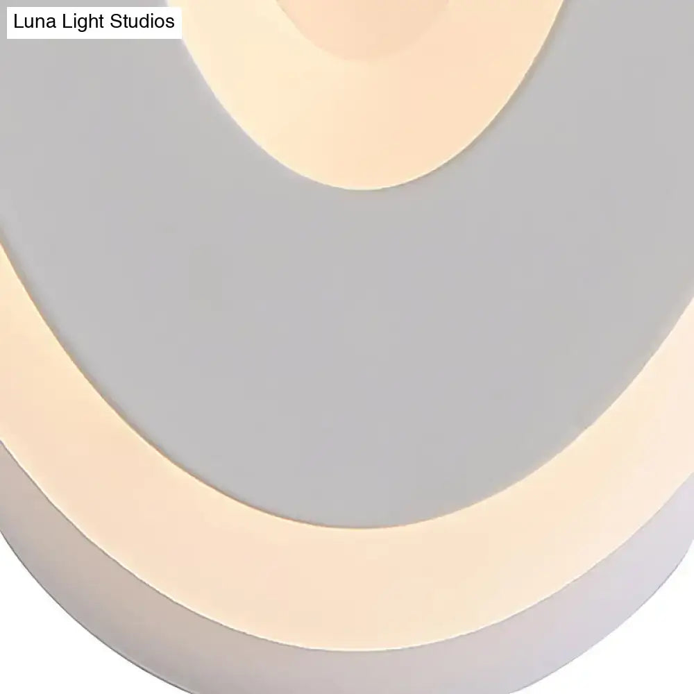 Modern black and cream oval direct wired electric wall lamp with layered beige and gray circular panels light type