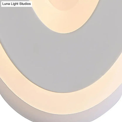 Modern black and cream oval direct wired electric wall lamp with layered beige and gray circular panels light type