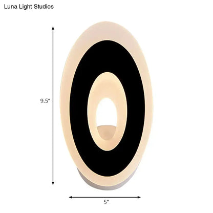 Modern black and cream oval direct wired electric wall lamp with illuminated inner ring light type for bedroom use