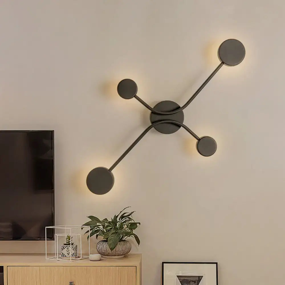 Modern black cross led wall lamp with matte black finish and four circular led light fixtures in geometric design